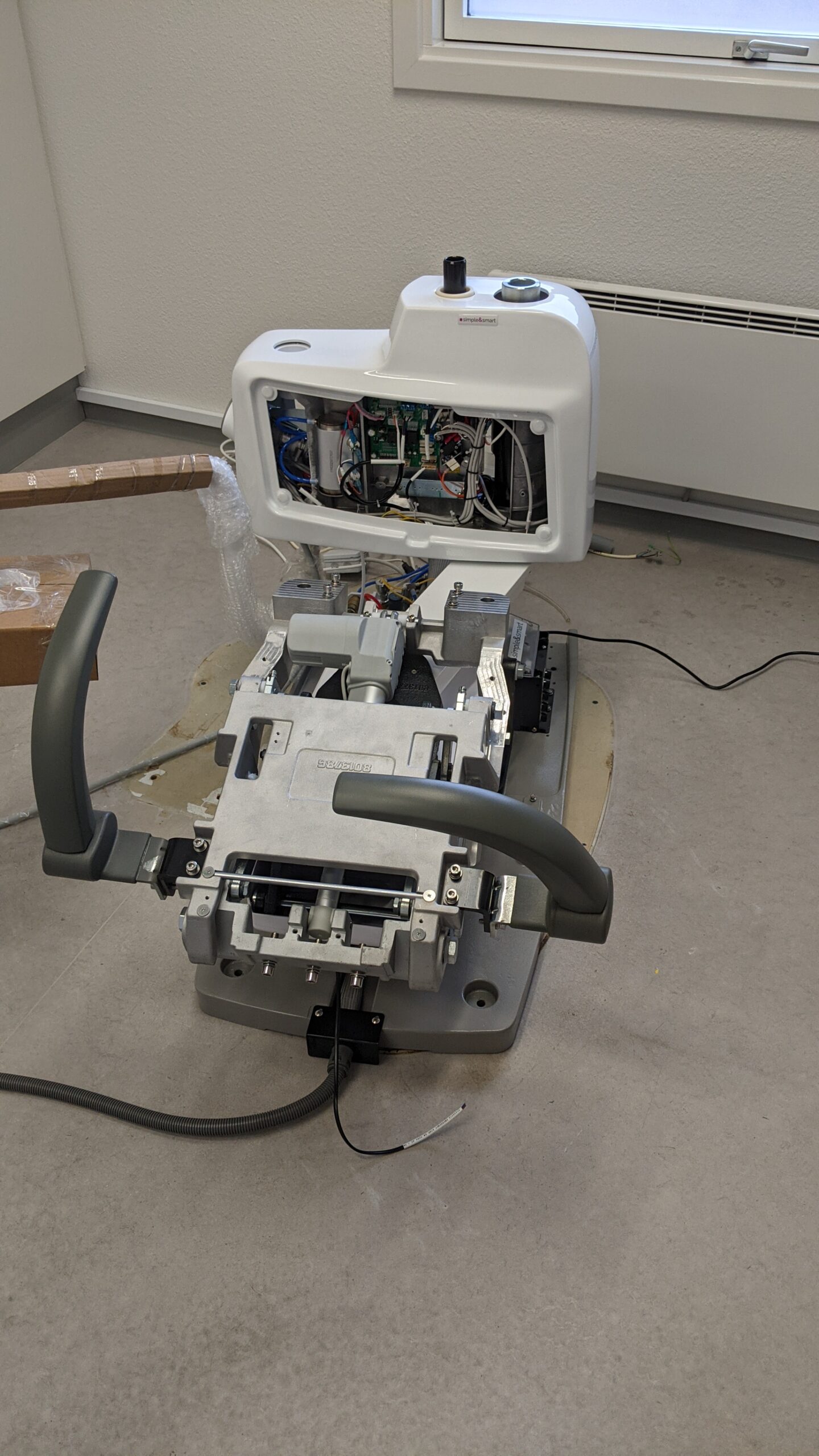 BioDen technician troubleshooting dental equipment with no power in a Vancouver clinic